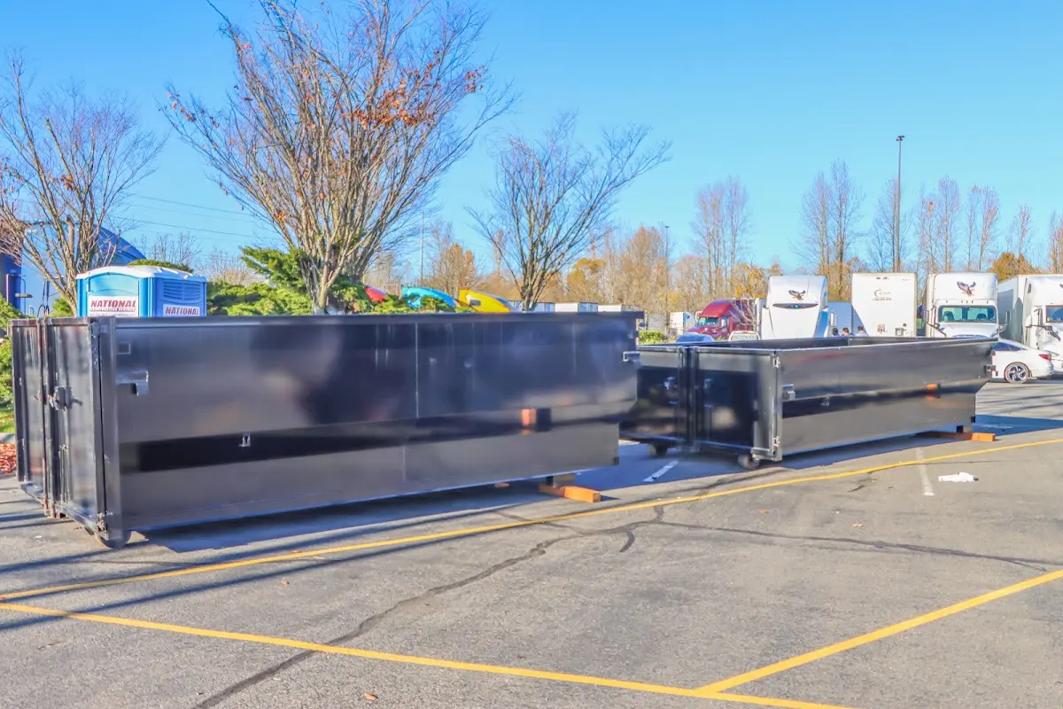 Professional dumpster rental service with roll-off container on residential driveway in Palm Coast